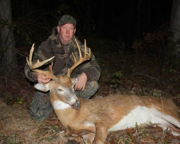 Hunter posing with shot deer