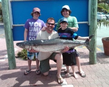 Family holding up tuna