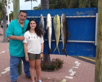 Guy and girl in front of the sailfish marina sign