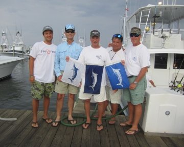 guys holding blue marlin flag